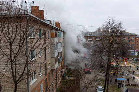 City Tula. Russia - December 01, 2020: Smoke during a fire in a multi-storey building. A fire truck and firemen arrived to eliminate the dangerous fire.のeditorial素材