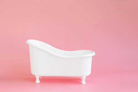 An empty white bathtub toy on pink backgroundの写真素材