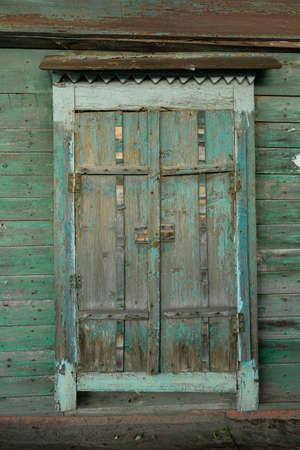 The window of an old wooden Russian house with beautiful shuttersの写真素材