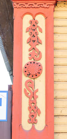 Wooden carved decoration on the facade of an old wooden house in Russia in the city of Tula.の写真素材