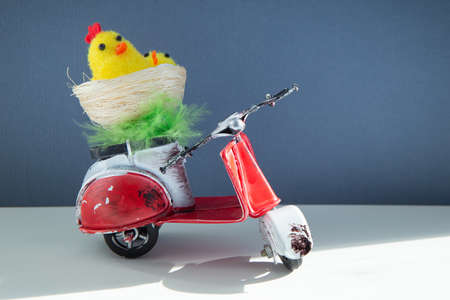 Chicken toys in a basket on a scooter.の写真素材