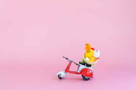 Chicken toys in a basket on a scooter.の写真素材