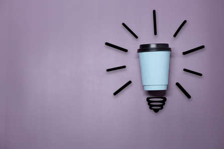 Creative thinking ideas and innovation concept. A ball of takeaway coffee cup with a light bulb symbol on a purple background. Time for coffee.の写真素材
