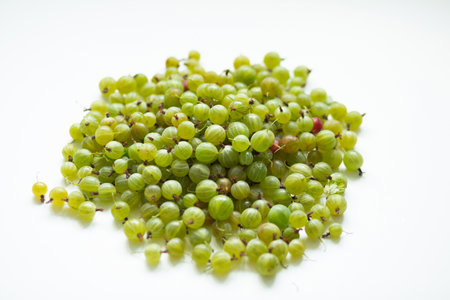 Hill of green gooseberries on a white backgroundの写真素材