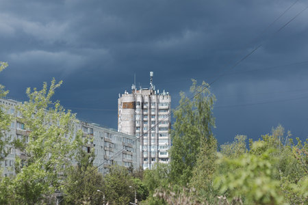 The dull autumn city landscape is a multi-storey building, the sky with dark cloudsの写真素材