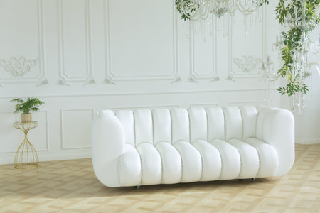 White leather sofa in a bright room against a white wallの写真素材