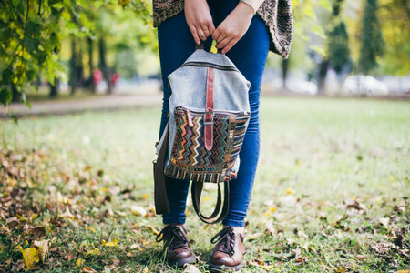 Girl holds in the hands a hipster backpackの写真素材