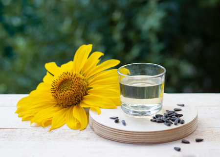 Close-up of sunflower oil in glass with seeds and sunflowerの写真素材