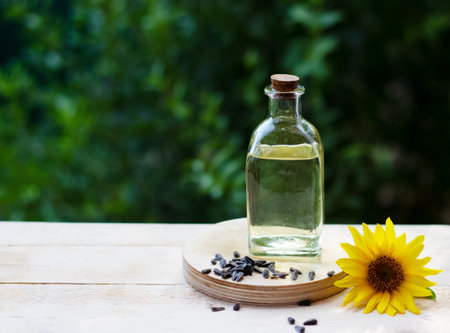 Close-up of sunflower oil in a bottle glass with seeds and sunflowerの写真素材