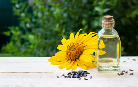 Close-up of sunflower oil in a bottle glass with seeds and sunflowerの写真素材