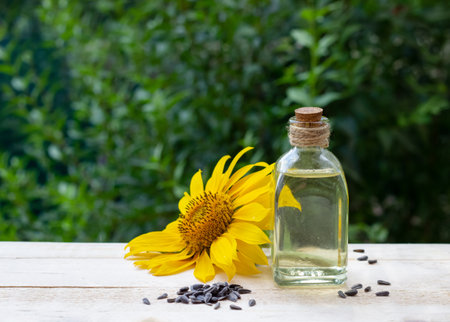 Close-up of sunflower oil in a bottle glass with seeds and sunflowerの写真素材