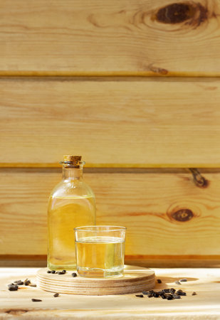Sunflower oil in a bottle glass with seeds on wooden backgroundの写真素材