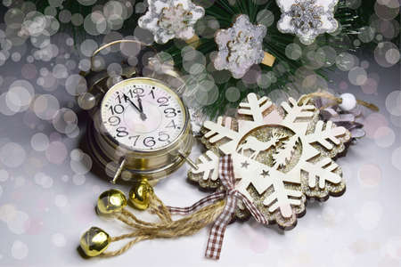 New Year clock Decorated with wooden snowflakes with sparkles and bokeh effect. Christmas and New...