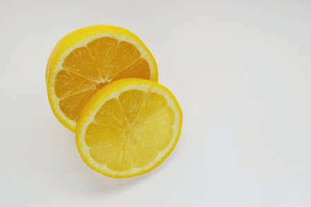 one yellow isolated lemon slice closeup on white backgroundの写真素材