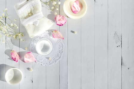 Beautiful spa composition with spring flowers on a light wooden background