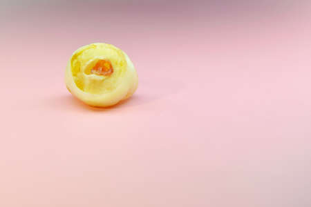 Loose milk tooth on neutral pink background with empty space for text. Kids dentistry. Loss molar...