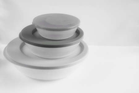Plastic food containers of different sizes, black and white photo.の写真素材