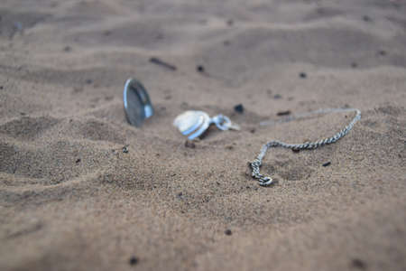 Alone Old pocket watch in the sand. Pocket watch in the sandの写真素材