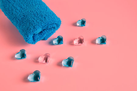 Beautiful composition of a towel with spa stones on a pink background. Holiday towelsの写真素材