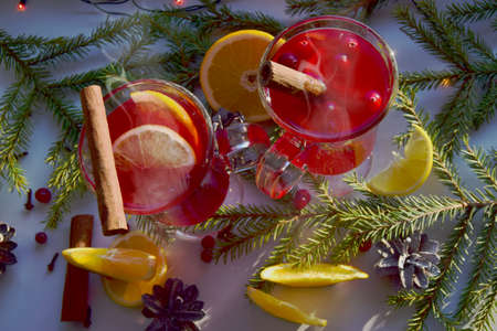 Mulled wine with spices and branches of a Christmas tree on a light windowsill, top view. Christmas...