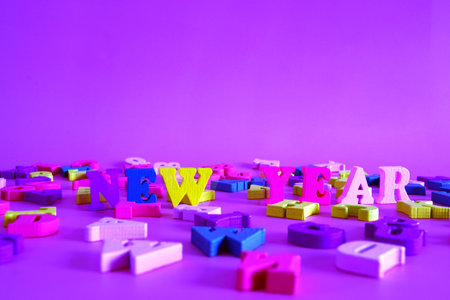 word New York on a lilac background consists of multicolored wooden letters in the abc alphabet block, copy space for your ad text. The concept of learning English.の写真素材