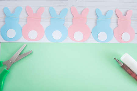 DIY and kids creativity. Step-by-step instructions: how to make an Easter bunny out of colored paper. Step 4. Handmade Easter craftの写真素材