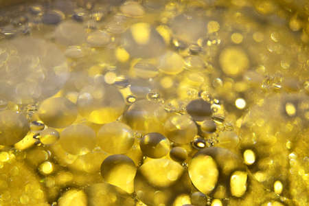 Defocused abstract background with yellow bubbles of oil in water. Macro photography, bocque. View from above.の写真素材