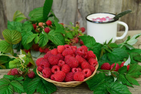 Fresh organic fruits - raspberries on a wood background selective focus. In the background, out of...