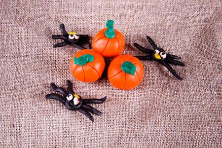 Spiders and pumpkins halloween concept on crumpled gray backgroundの写真素材
