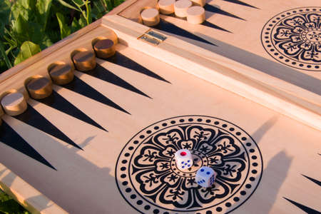 throwing dice in backgammon board game close up, selective focus.
