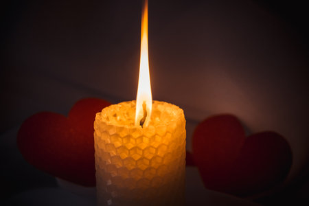 burning candle, a symbol of the moon, an amulet lying on a red natural background. pagan wiccan, slavic traditions. Witchcraft, esoteric spiritual ritual. autumn equinox festival. close upの写真素材