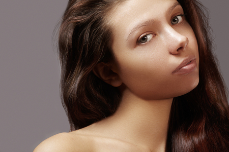 Beautiful young woman with clean skin, shiny hair, fashion makeup. Glamour make-up, perfect shape eyebrows. Portrait sexy brunetteの写真素材