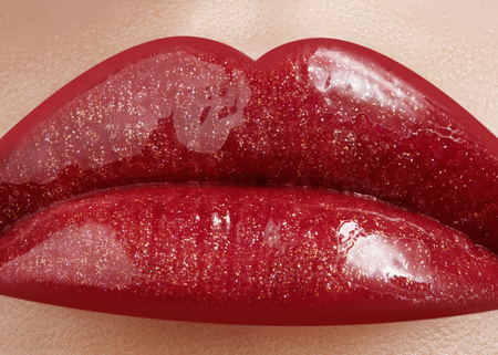 Close-up of female lips with bright makeup. Macro of woman's face. Fashion lip make-up with red gloss.Red lipgloss makeup on full female lipsの写真素材