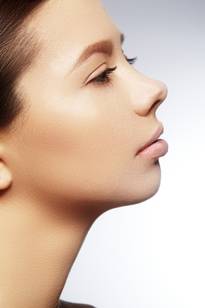 Beautiful young woman with perfect clean shiny skin, natural fashion makeup. Close-up woman, fresh spa lookの写真素材