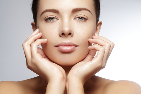 Beautiful young woman with perfect clean shiny skin, natural fashion makeup. Close-up woman, fresh spa lookの写真素材