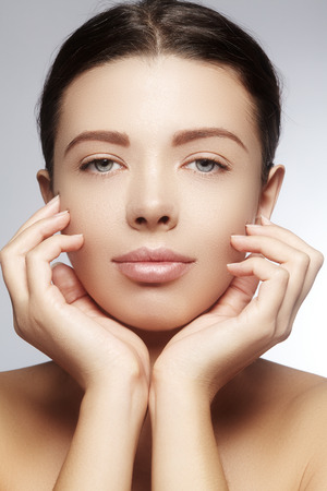 Beautiful young woman with perfect clean shiny skin, natural fashion makeup. Close-up woman, fresh spa lookの写真素材