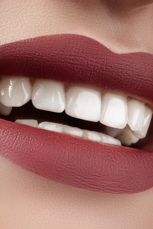 Beautiful smile with whitening teeth. Dental photo. Macro closeup of perfect female mouth, lipscare rutine.の写真素材
