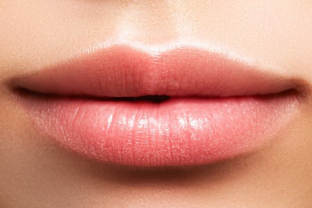 Close-up perfect natural lip makeup beautiful female mouth. Plump sexy full lips. Macro photo face detail. Perfect clean skin, fresh lip make-up. Beautiful spa tender lipsの写真素材