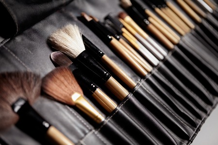 Set of make-up brushes in black makeup bag. Beauty tools for professional visage. Brushes for...