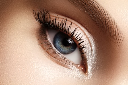 Beautiful macro shot of female eye with extreme long eyelashes and black liner makeup. Perfect shape make-up and long lashes. Cosmetics and make-up. Closeup macro shot of fashion eyes visageの写真素材