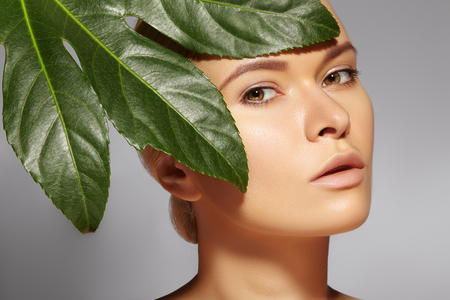 Beautiful woman applies Organic Cosmetic and oils for Beauty. Spa and Wellness. Model with Clean Skin, shiny hair. Healthcare.の写真素材