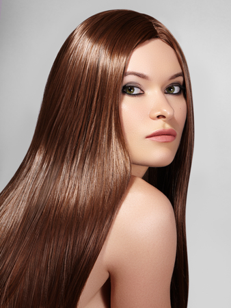 Beautiful yong Woman with Long Straight Brown Hair. Sexy Fashion Model with Smooth gloss Hairstyle. Beauty with Make-up, keratin treatmentの写真素材