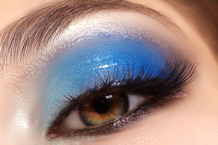 Closeup female eyes with bright make-up, great shapes brows, extreme long eyelashes. Celebrate makeup, luxury eyeshadows. Macro of beautiful eye. Good visionの写真素材