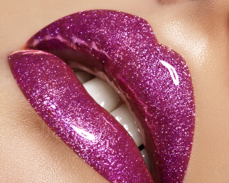 Glamour magenta gloss lip make-up. Fashion makeup beauty shot. Close-up female sexy full lips with celebrate pink gloss lipstickの写真素材