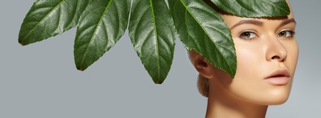 Beautiful woman applies Organic Cosmetic and oils for Beauty. Spa and Wellness. Model with Clean Skin, shiny hair. Healthcare.の写真素材