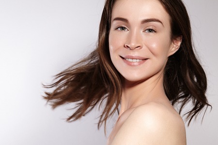 Beautiful Smiling Woman with Clean Skin, Natural Make-Up. Joyfull and Happiness. Emotional Female Face. Health and Wellness. Love Yourselfの写真素材
