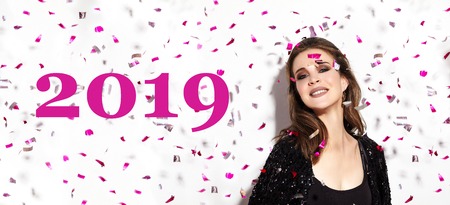 Christmas Party Time. Beautiful Happy Woman Smiling. Style in Confetti. New Year 2019 Celebrate Look...