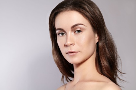 Beauty Woman Face Portrait. Beautiful Spa Model Girl with Perfect Fresh Clean Skin. Youth and Skin Care Concept.の写真素材