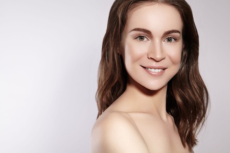 Beautiful Smiling Woman with Clean Skin, Natural Make-Up. Joyfull and Happiness. Emotional Female Face. Health and Wellness. Love Yourselfの写真素材