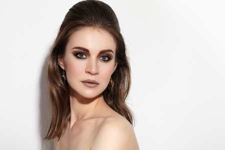 Beautiful Woman with Professional Makeup. Celebrate Style Eye Make-up, Perfect Eyebrows, Shine Skin. Bright Fashion Look.の写真素材